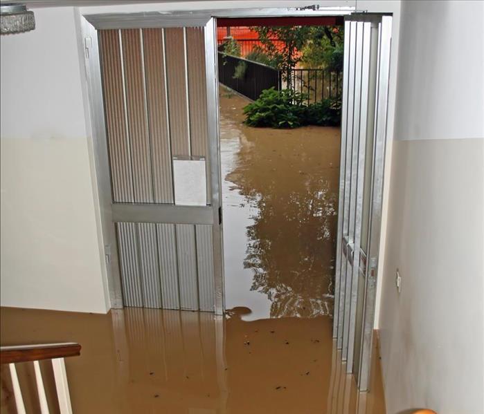 Floodwaters enters a home, water reaches the stairs from the house